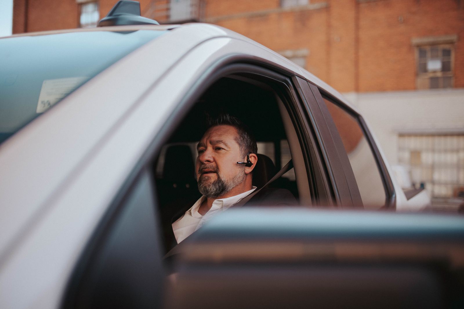 Lifestyle photography of a driver wearing a wireless headset