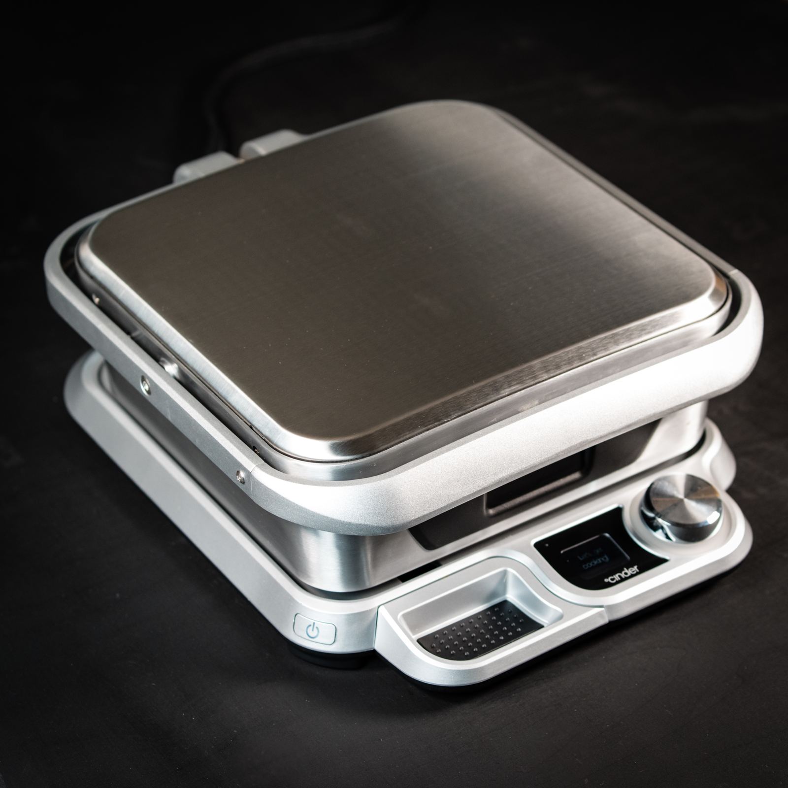 Stainless waffle maker studio product photography on black
